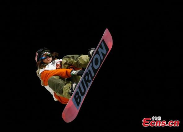 An athlete competes in the first stop of the 2015 Air + Style Tour in the National Stadium, more commonly known as the Bird's Nest, in Beijing, Dec. 4, 2015. A total of 24 athletes participated in the qualification of the snowboarding event on Friday. (Photo: China News Service/Du Yang)