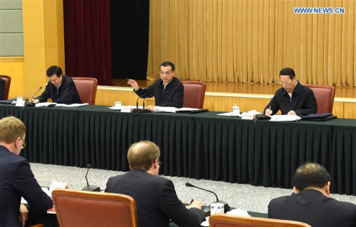 Chinese Premier Li Keqiang (5th R back) hosts a symposium on the compiling of China's 13th Five-Year Plan at the headquarters of China's National Development and Reform Commission in Beijing, capital of China, on Dec. 7, 2015. (Xinhua/Rao Aimin)
