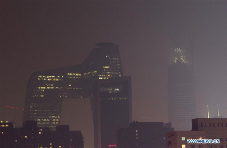 Photo taken on Dec. 7, 2015 shows skyscrapers of the Central Business District (CBD) covered in smog in Beijing, capital of China. Beijing issued the red alert for the heavy pollution on Dec. 7, the first ever which is the most serious level. The red alert will last from 7:00 a.m. Tuesday to 12:00 p.m. Thursday. (Photo: Xinhua/Wu Wei)