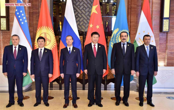 Chinese President Xi Jinping (3rd R) meets with leaders of members of the Shanghai Cooperation Organization (SCO), namely Tajikistan's Prime Minister Qohir Rasulzoda (1st R), Kazakhstan's Prime Minister Karim Masimov (2nd R), Russian Prime Minister Dmitry Medvedev (3rd L), Kyrgyzstan's Prime Minister Temir Sariyev (2nd L) and First Deputy Prime Minister of Uzbekistan Rustam Azimov (1st L), in Wuzhen Town, east China's Zhejiang Province, Dec. 16, 2015. (Photo: Xinhua/Li Tao) 