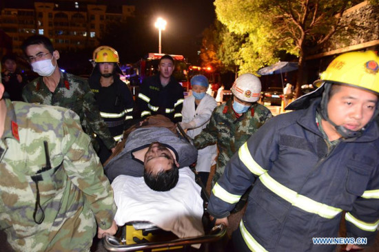 Rescuers transfer an injured man after a blast happened in the kitchen of a restaurant in the Xinluo District of Longyan City, southeast China's Fujian Province, Dec. 16, 2015. Seven people were killed in the explosion, which occurred Wednesday evening. Three others are receiving emergency treatment in a hospital. (Xinhua/Zhou Yangdong)