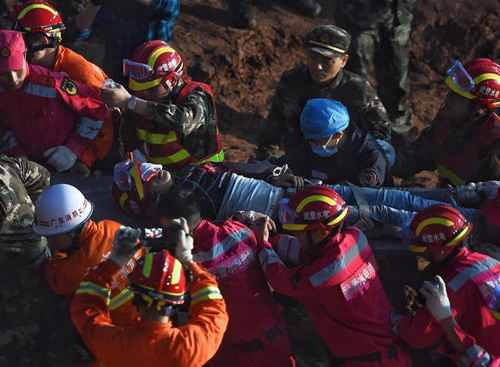 A survivor is found at the site of landslide at an industrial park in Shenzhen, south China's Guangdong Province, Dec. 23, 2015. One man was pulled out alive early Wednesday morning more than 60 hours after a landslide in Shenzhen. (Xinhua/Jin Liangkuai)