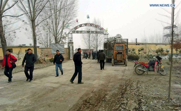 People are seen outside the entrance of a gypsum mine in Pingyi County, east China's Shandong Province, Dec. 25, 2015. A gypsum mine collapsed in Pingyi Friday, burying many people, sources with the local government said, without giving further details. A rescue operation has been launched. (Xinhua) 