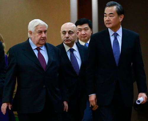 Foreign Minister Wang Yi (right) joins his visiting Syrian counterpart Walid al-Moallem for a media briefing in Beijing on Thursday. 