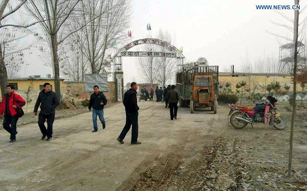 People are seen outside the entrance of a gypsum mine in Pingyi County, east China's Shandong Province, Dec. 25, 2015. A gypsum mine collapsed in Pingyi Friday, burying many people, sources with the local government said, without giving further details. A rescue operation has been launched. (Photo/Xinhua) 