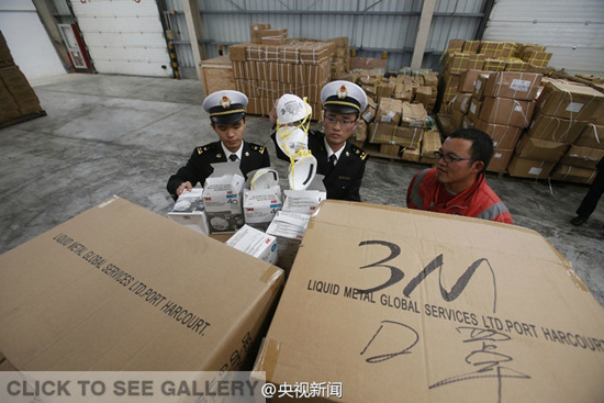 Shanghai Customs officers inspect masks that turned out to be fakes. They seized nearly 120,000 counterfeit masks that carried the 