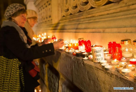 eople light candles to mourn the victims of the Paris terrorist attacks in front of Saint Stephen Basilica in Budapest, Hungary, on Nov. 14, 2015. (Photo/Xinhua)