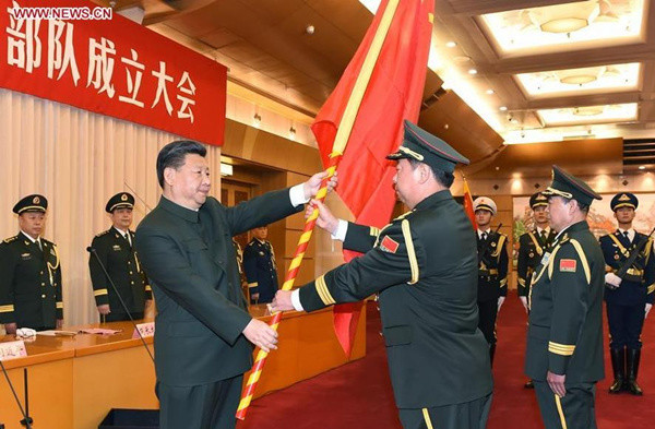 Chinese President Xi Jinping (L F), confers the military flag to Li Zuocheng (C F), commander of the Army of the Chinese People's Liberation Army (PLA), and Liu Lei, political commissar of the Army, in Beijing, capital of China, Dec. 31, 2015. The general commands of the PLA Army, Rocket Force and Strategic Support Force were founded on Thursday. (Photo: Xinhua/Li Gang)