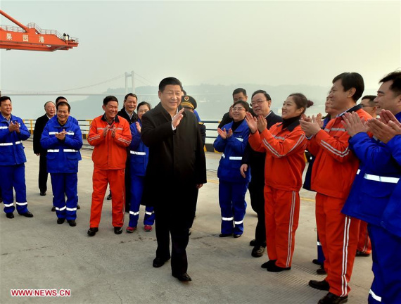 Chinese President Xi Jinping (C) greets workers during his visit to Guoyuan Port in southwest China's Chongqing Municipality, Jan. 4, 2016. Xi made an inspection tour in Chongqing from Jan. 4 to 6. (Photo: Xinhua/Li Tao)