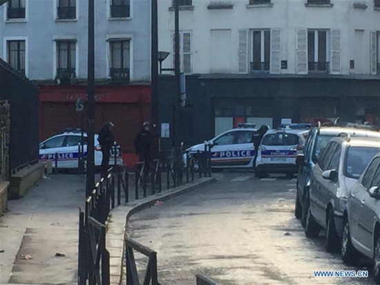 Photo taken on Jan. 7, 2016 shows policemen stand guard in the 18th district in Paris. Police shot dead a man armed with a knife trying to enter the police station in the French capital 18th district, according to local media. (Photo: Xinhua/Han Bing)