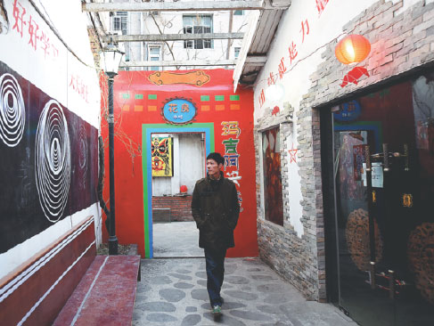 A man walks past a bar in the neighborhood which was transformed from a shabby village on Shuguang Road in Hefei, Anhui province.
