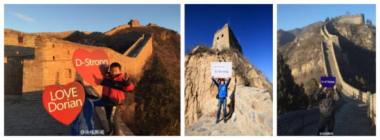 People hold signs with the words D-Strong at the Great Wall in Beijing. (Photo/CCTV's SinWeibo account)