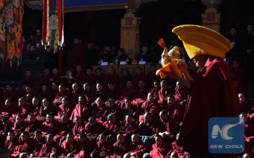 A Buddhist prepares to serve tea to Panchen during the 20th anniversary of the enthronement of Bainqen Erdini Qoigyijabu, the 11th Panchen Lama, one of the two most revered living Buddhas in Tibetan Buddhism, in Tashilhunpo Monastery in Xigaze, southwest China's Tibet Autonomous Region, Dec. 8, 2015. (Xinhua file photo/Chogo)