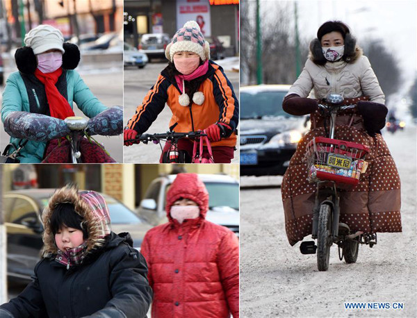 Residents are seens wearing heavy in Binzhou, east China's Shandong Province on Jan. 23, 2016. Lowest temperature dropped to minus 19 degrees Celsius here on Saturday. (Xinhua/Zhou Ke) 