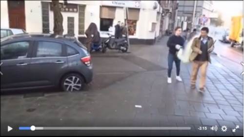 An image from a video shows a man throwing baby formula at a Chinese national on the street in the Netherlands. (Photo/thepaper.cn)