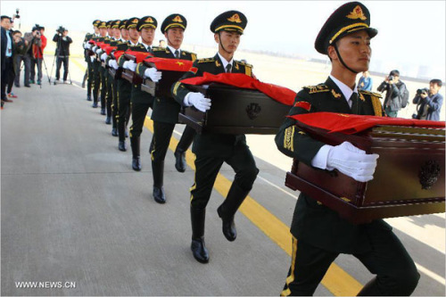 Soldiers of the Chinese People's Liberation Army carry coffins containing remains of soldiers of the Chinese People's Volunteers (CPV) dead in the 1950-53 Korean War, during a handover ceremony at the Inchon International Airport of South Korea, March 20, 2015. (Photo: Xinhua/Yao Qilin)