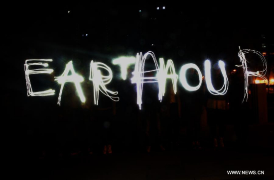 People in a community write the words of EARTH HOUR with light during the annual Earth Hour campaign in Qinhuangdao, north China's Hebei Province, March 28, 2015. (Photo: Xinhua/Yang Shirao)