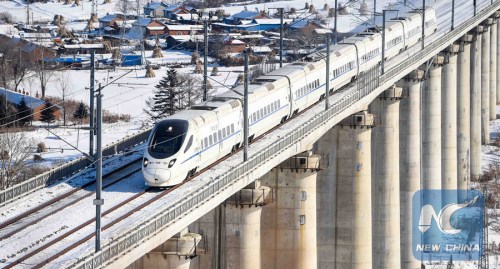 A bullet train drives in Jiaohe City, northeast China's Jilin Province, Jan. 26, 2016. (Photo: Xinhua/Wang Haofei)
