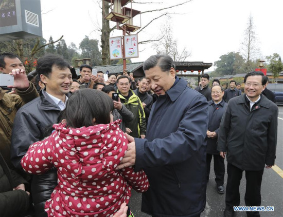 Chinese President Xi Jinping (R, front), also general secretary of the Communist Party of China (CPC) Central Committee and chairman of the Central Military Commission, talks with villagers while visiting revolutionary site in Jinggangshan, east China's Jiangxi Province, Feb. 2, 2016. (Photo: Xinhua/Lan Hongguang)