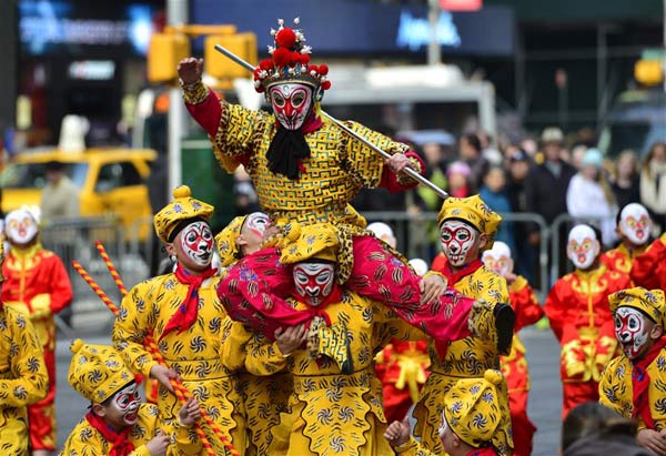 A flash mob featuring a hundred performers in monkey costumes makes an appearance to celebrate the arrival of the Chinese New Year in Times Square on Manhattan, New York, the United States, Feb. 6, 2016.The event is an effort to let people from all over the world experience the beauty of Chinese culture, and, in a move to convey the New Year's blessings. (Photo: Xinhua/Wang Lei)