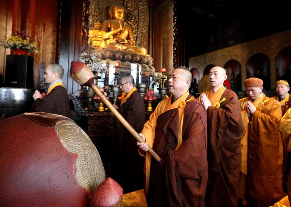 Monks pray at the Guangji temple in Beijing on Friday for the dead and survivors of the powerful earthquake that struck southern Taiwan. The prayers were offered on the fifth day of Spring Festival. The event, which was held by the Buddhist Association of China, attracted hundreds of people. Wang Zhuangfei / China Daily