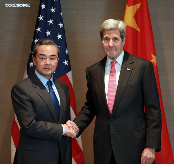 Chinese Foreign Minister Wang Yi (L) meets with U.S. Secretary of State John Kerry in Munich, Germany, Feb. 12, 2016. (Xinhua/Luo Huanhuan)