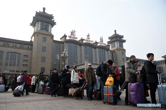Passengers leave Beijing Railway Station in downtown Beijing, capital of China, Feb. 12, 2016. Railway stations around the nation witnessed surging passenger flows on Friday as the Spring Festival came to the end and people started to return to school and work. (Photo: Xinhua)