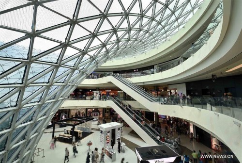 People visit Haitang Bay duty-free shopping center in Sanya, south China's Hainan Province, Jan. 31, 2016. (Photo: Xinhua/Guo Cheng)