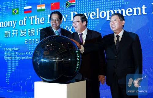 Chinese Finance Minister Lou Jiwei (C), Shanghai Mayor Yang Xiong (R) and President of the New Development Bank (NDB) of BRICS K.V. Kamath attend the launching ceremony of the bank in Shanghai, east China, July 21, 2015. The New Development Bank (NDB) of BRICS opened in Shanghai on Tuesday to finance infrastructure projects, mainly in BRICS members. (Xinhua file photo/Zhang Chunhai)