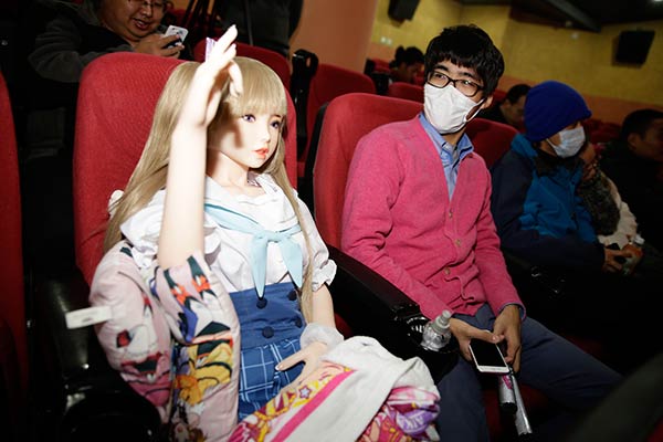 A man sits beside a doll at an entertainment event in Beijing last November. (Photo: China Daily/Dong Dalu)
