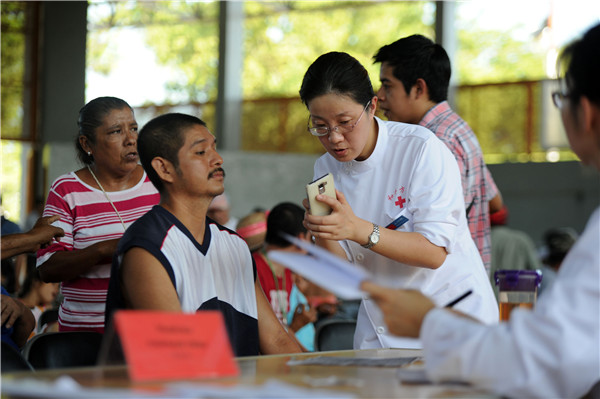 A Chinese doctor tries to communicate with her Mexican patient with the help of Baidu translate app on her smartphone.(Photo/China Daily)