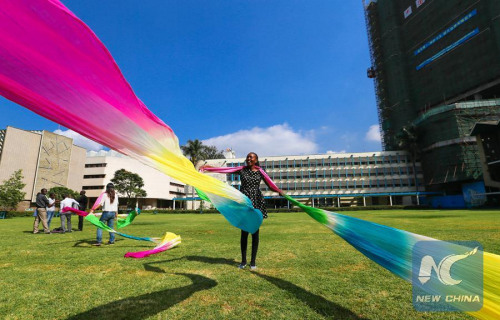 Wynn Kendi, a Chinese language student at the Confucius Institute of Kenya's University of Nairobi, practises Chinese dance on the campus, June 26, 2015. (Photo: Xinhua/Pan Siwei)