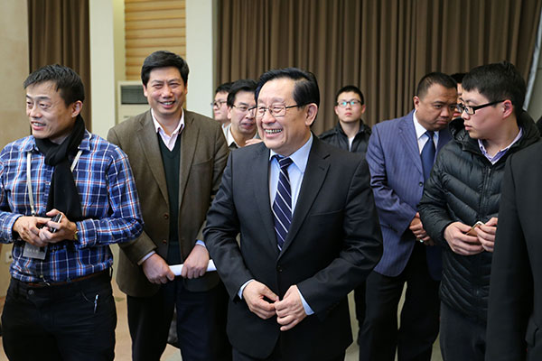 Wan Gang (center), minister of science and technology, interacts with journalists after a news conference on China's scientific reform and progress in Beijing on Wednesday. WANG ZHUANGFEI/CHINA DAILY