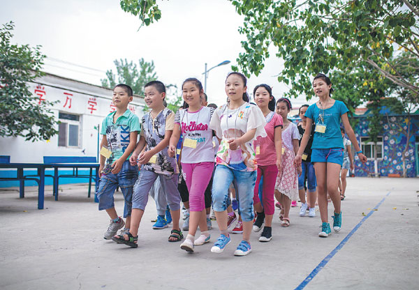 Students attend military training at Beijing's Dandelion School, a nonprofit institute for the children of migrant workers, in July. Zheng Liang / For China Daily