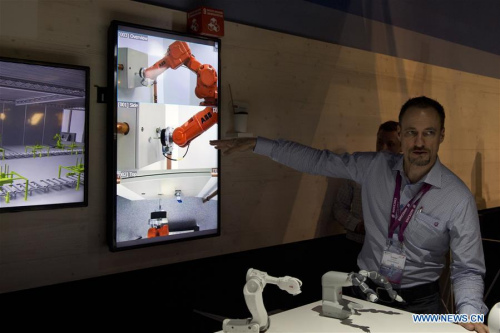 A promoter of Swedish company Ericsson shows some details of the 5G for industries technology which allow people to control machines wireless from any distance in Barcelona, Spain, Feb. 23, 2016. The Mobile World Congress (MWC), the most important mobile communication event in the world, opened its doors in Barcelona Monday. (Photo: Xinhua/Lino De Vallier)