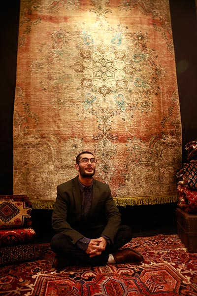 Matin Zamani displays his collection of handmade Persian rugs at Beijing's Four Seasons hotel. (Photo: China Daily/Feng Yongbin)
