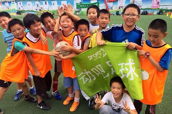 A group of children pose for the camera during a training session organized by Sport8 in Beijing. (Photo provided to China Daily)