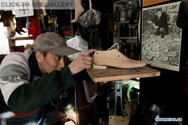 hang Guoqing checks the shape of a newly-made shoe tree in his workshop in Beijing, capital of China, Feb. 1, 2016. (Photo: Xinhua/Wu Kaixiang)