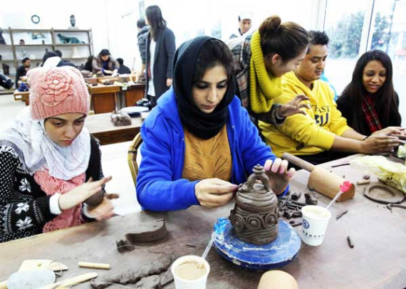 Foreign students during a pottery class at a Chinese cultural activity in Yixing, Jiangsu, in December. DING HUANXIN / FOR CHINA DAILY