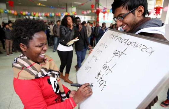 Musiyazwiriyo Selina Vimba, a student from Zimbabwe, joins in a game to celebrate Spring Festival at Jiangsu University in Zhenjiang, Jiangsu province, on Feb 2. YANG YU / FOR CHINA DAILY