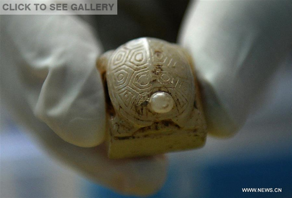 Photo taken on Dec. 13, 2015 shows a turtle-shaped jade stamp unearthed from the tomb in the Haihunhou (Marquis of Haihun) cemetery, east China's Jiangxi Province. (Photo: Xinhua/Wan Xiang)