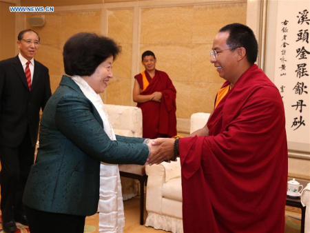 Sun Chunlan (L front), member of the Political Bureau of the Communist Party of China (CPC) Central Committee and head of the United Front Work Department of the CPC Central Committee, meets with the 11th Panchen Lama Bainqen Erdini Qoigyijabu, in Beijing, capital of China, March 1, 2016. (Xinhua/Pang Xinglei)