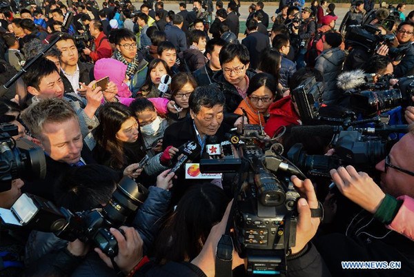 Zong Qinghou, a deputy to the 12th National People's Congress (NPC), is surrounded by journalists in Beijing, capital of China, March 5, 2015. The third session of the 12th NPC opened in Beijing on March 5. (Photo/Xinhua)