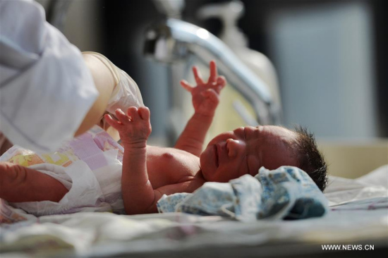 A maternity nurse takes care of a newborn after bath at the Gansu Provincial Maternity and Child-care Hospital in Lanzhou, capital of northwest China's Gansu Province, Feb. 17, 2016. The hospital saw baby boom at the beginning of the Chinese Lunar New Year, with 352 babies born from Feb. 8 to 15. (Photo: Xinhua/Chen Bin)