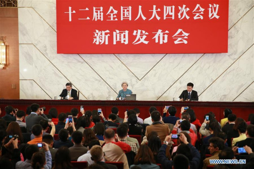 u Ying (C, back), spokesperson for the fourth session of China's 12th National People's Congress (NPC), answers questions during a press conference on the session at the Great Hall of the People in Beijing, capital of China, March 4, 2016. The fourth session of the 12th NPC is scheduled to open in Beijing on March 5. (Photo: Xinhua/Ding Haitao)