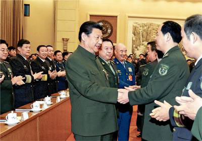 Chinese President Xi Jinping (C), also general secretary of the Communist Party of China (CPC) Central Committee and chairman of the Central Military Commission, shakes hands with deputies to the 12th National People's Congress (NPC) from the People's Liberation Army (PLA) and joins a plenary meeting of the PLA delegation during the third session of the 12th NPC in Beijing, capital of China, March 12, 2015. (Photo/People's Daily Online)