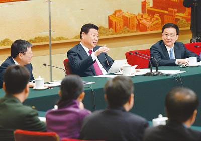 Chinese President Xi Jinping (C), also general secretary of the Communist Party of China (CPC) Central Committee and chairman of the Central Military Commission, joins the panel discussion with National People's Congress (NPC) deputies from Shanghai during the second session of the 12th NPC, in Beijing, March 5, 2014. (Photo/People's Daily Online)