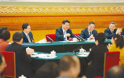 Chinese President Xi Jinping (C), also general secretary of the Communist Party of China (CPC) Central Committee and chairman of the Central Military Commission, joins the panel discussion with National People's Congress (NPC) deputies from Guangdong province during the second session of the 12th NPC, in Beijing, March 6, 2014. (Photo/People's Daily Online)