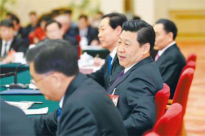 Chinese President Xi Jinping (C), also general secretary of the Communist Party of China (CPC) Central Committee and chairman of the Central Military Commission, joins the panel discussion with National People's Congress (NPC) deputies from Anhui province during the second session of the 12th NPC, in Beijing, March 9, 2014. (Photo/People's Daily Online)