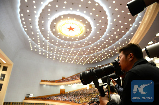 Photographers work at the Great Hall of the People during the opening meeting of the fourth session of China's 12th National People's Congress in Beijing, capital of China, March 5, 2016. (Photo: Xinhua/Liu Junxi)